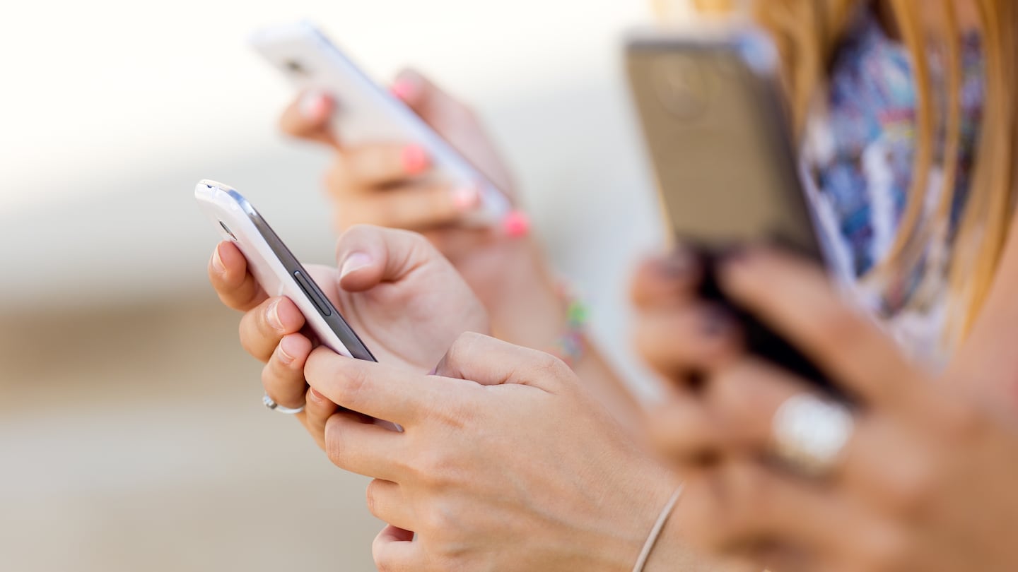 A stock image of women holding phones