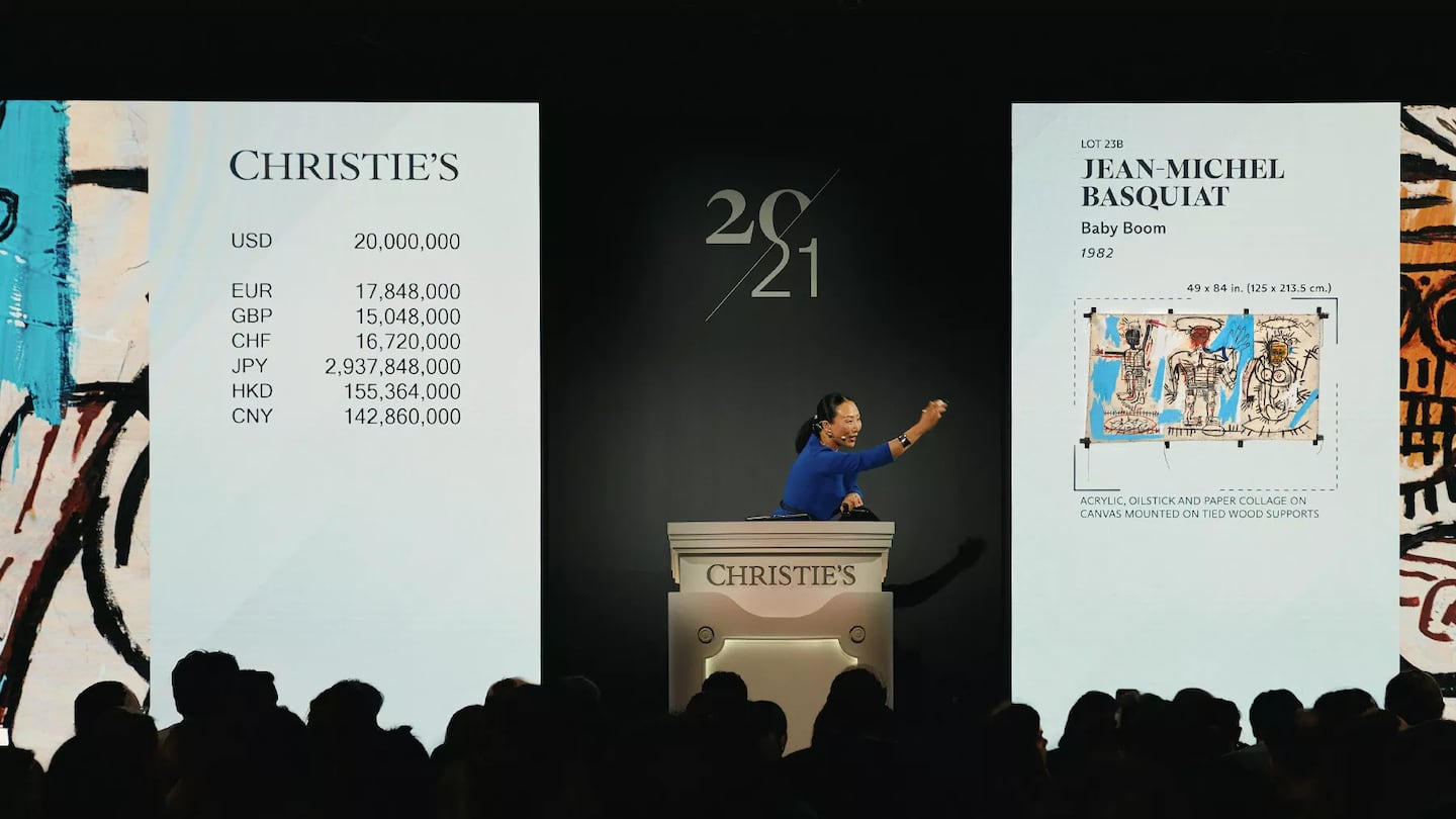 Auctioneer Yü-Ge Wang sells Jean-Michel Basquiat’s Baby Boom for $23.4 million.
